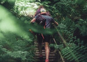 Hiker climbing the zero waste journey stairs.