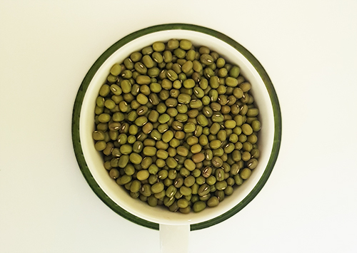 Cup of dried mung beans viewed from top.