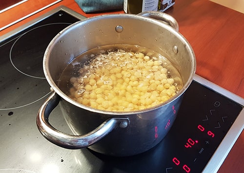 Chickpeas boiling in a pot.