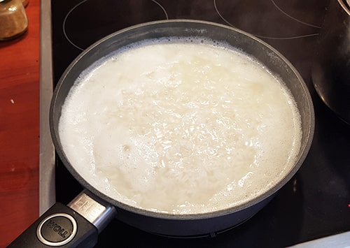 Rice cooking in a pan for a Poke Bowl.