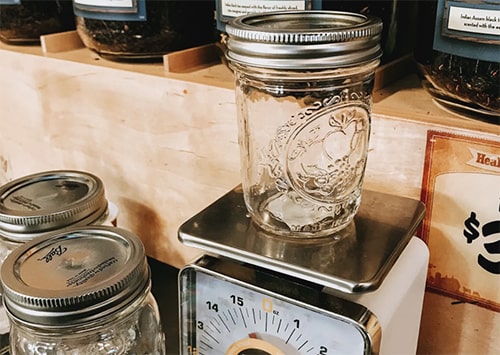 Tare of a Mason jar being scaled in a bulk shop.