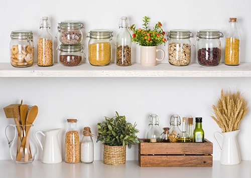 Sustainable pantry shelf with mason jars and food ingredients.