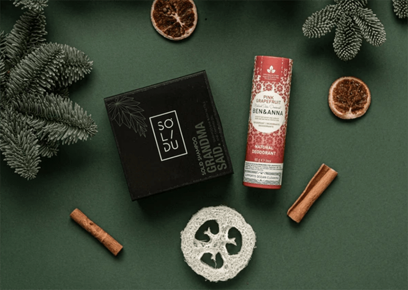 Dry shampoo and package-free deodorant with christmas decoration.