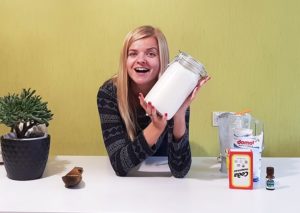 Girl holding a mason jar full of home-mode laundry soap.