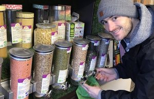 Founder buying food in bulk in a zero waste shop.